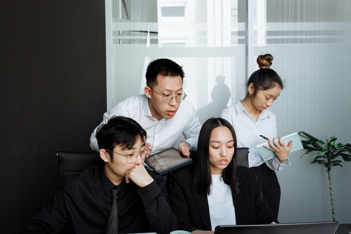 Two colleagues going through work on a laptop